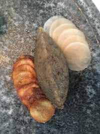 a plate with a potato and a piece of bread